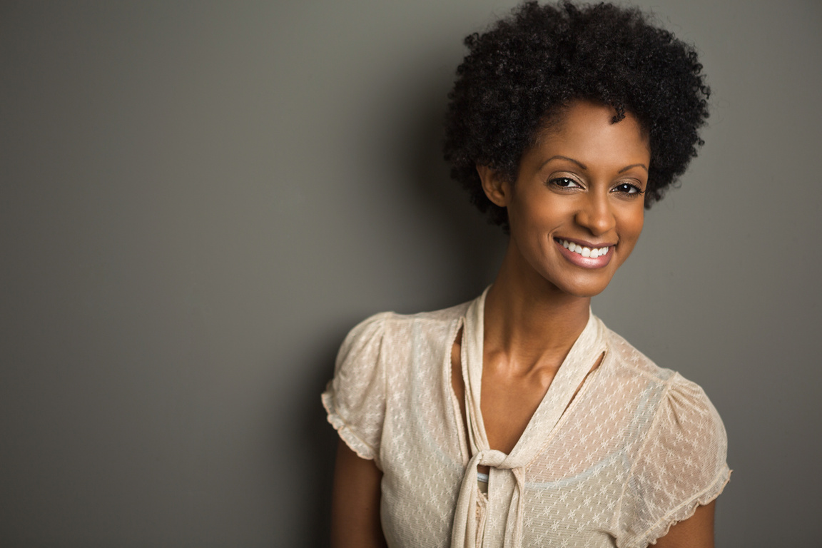 Fashionable Beautiful Young Woman on a Dark Background